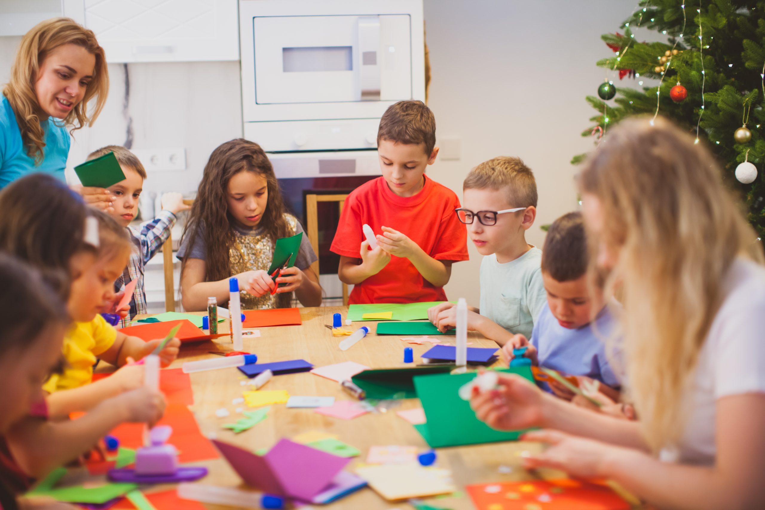 Group of kids and teachers making greeting cards